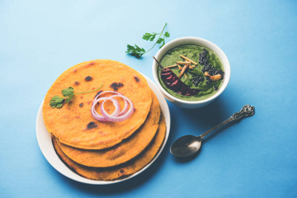 istock Makki di roti with sarson ka saag, popular punjabi main course recipe in winters made using corn breads mustard leaves curry. served over moody background. selective focus 1077212118