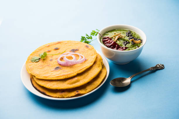 istock Makki di roti with sarson ka saag, popular punjabi main course recipe in winters made using corn breads mustard leaves curry. served over moody background. selective focus 1077212256