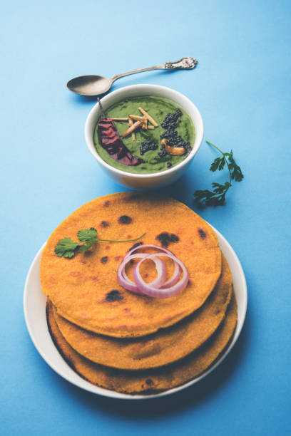 istock Makki di roti with sarson ka saag, popular punjabi main course recipe in winters made using corn breads mustard leaves curry. served over moody background. selective focus 1077212460
