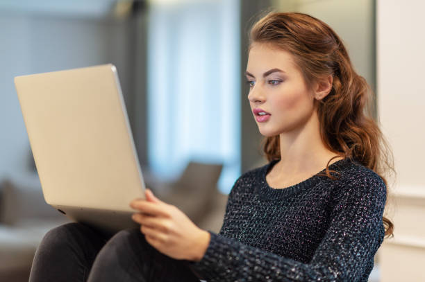 istock Attractive  woman with laptop at home. 1077212962