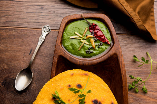 istock Makki di roti with sarson ka saag, popular punjabi main course recipe in winters made using corn breads mustard leaves curry. served over moody background. selective focus 1077213252
