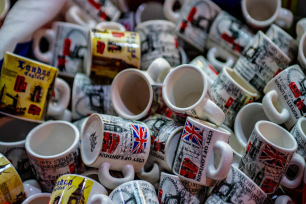 Mugs outside a London gift shop. A large collection of tea or coffee mugs with traditional London icons and scenes on them for sale in a bin outside a gift shop.