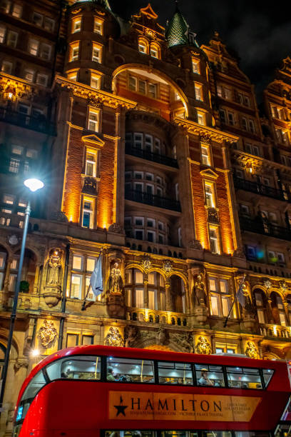 London Double-Decker bus advertising the musical Hamilton outside a hotel.
