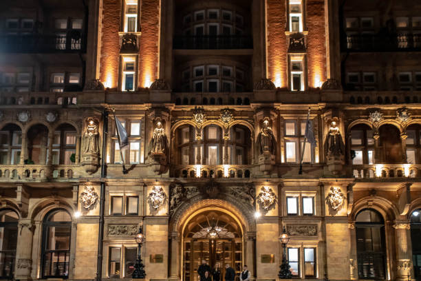 Russell Rooms hotel on Russell Square at night near Christmas.  their are staff and guests near the entrance.