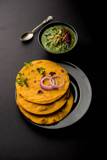 istock Makki di roti with sarson ka saag, popular punjabi main course recipe in winters made using corn breads mustard leaves curry. served over moody background. selective focus 1077217798