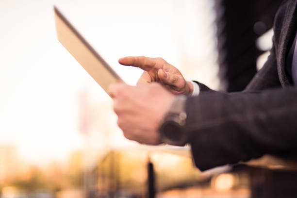istock Mid adult businessman using a digital tablet. 1077221810