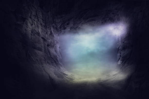 the stone cave inside. out way with spooky mist and fog stock photo