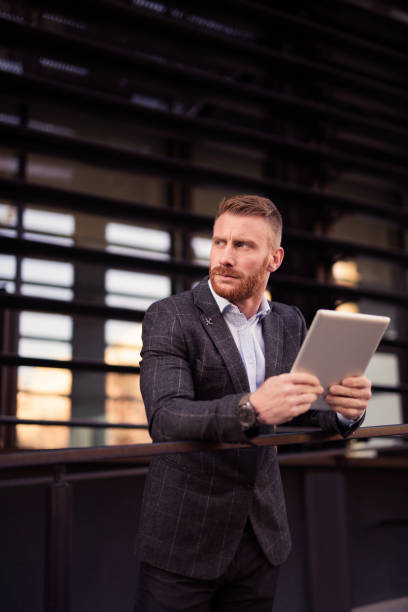 istock Mid adult businessman using a digital tablet. 1077227418