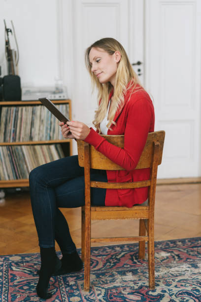 istock Slender young woman relaxing with her tablet-pc 1077229260