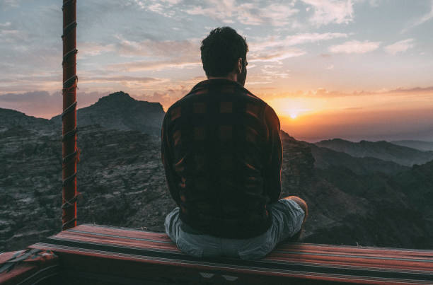 istock Young traveller admiring the sunset in Petra 1077229284