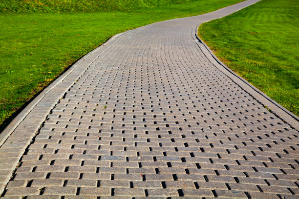 istock Stone path in the park and green lawn. 1077229404