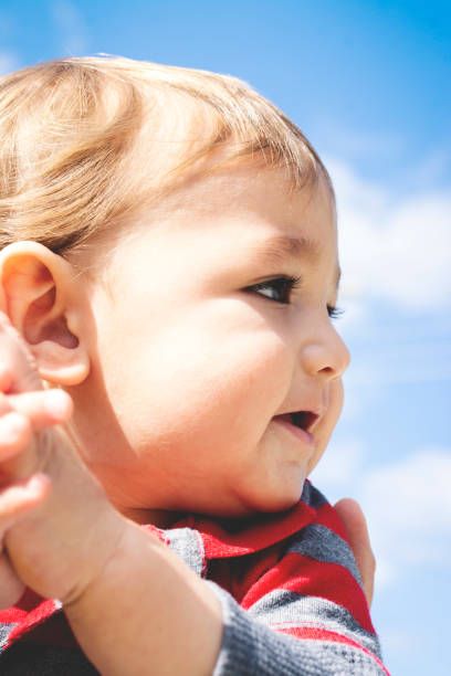istock Cute little boy with the sky in the background. 1077230518
