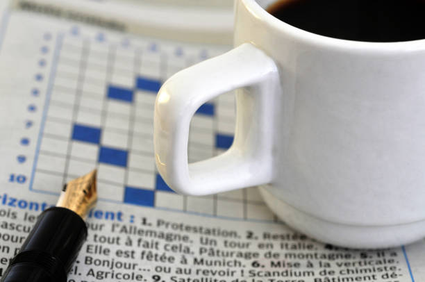 istock Coffee and crossword puzzles 1077234710