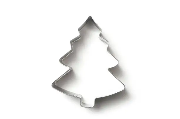 closeup of Christmas fir tree shape cookie cutter on white background