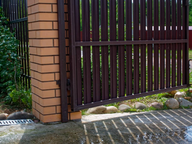 istock sunlight through a metal fence in summer 1077240970