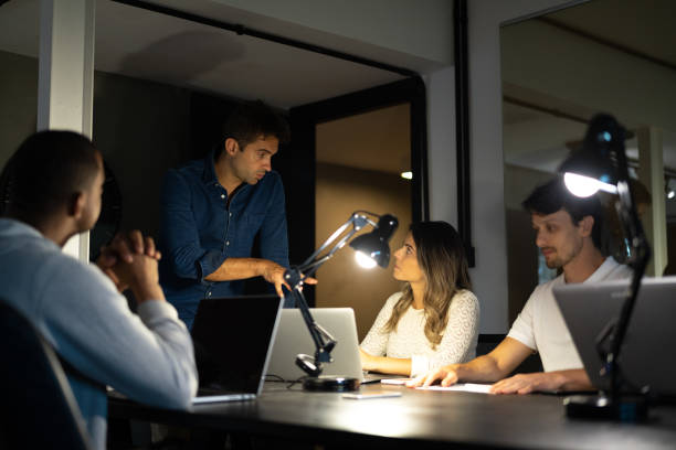 istock Businessman leading team at late working 1077241386