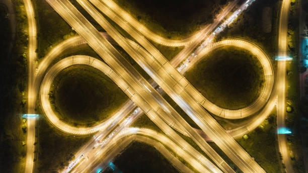 istock Aerial top view highway road intersection roundabout or circle at night for transportation, distribution or traffic background. 1077250058