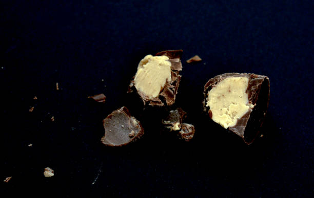 istock cut bonbon praline on a black background 1077250354