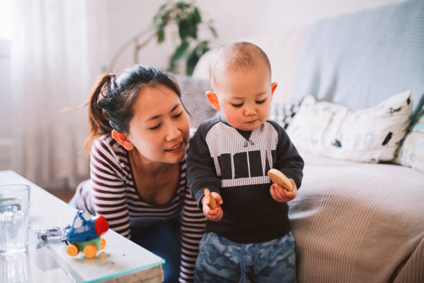 istock Young Asian mom with her baby boy 1077253812