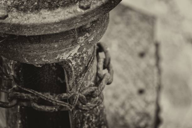 istock Monochrome Rusty steel chain element, industrial background for commercial 1077257530