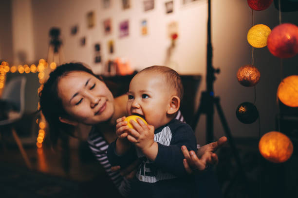 istock Young Asian playing at home with her baby boy 1077257976