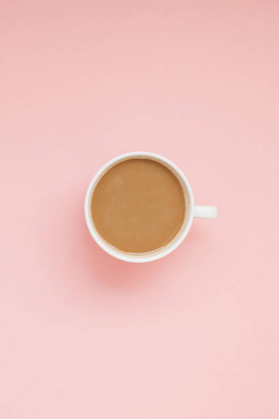istock Cup of coffee with milk on pink background 1077258174