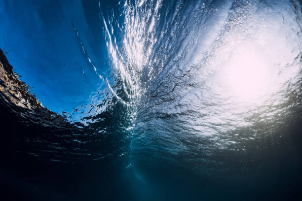 istock Blue barrel wave crashing in ocean and sunlight. Wave texture underwater. 1077258178
