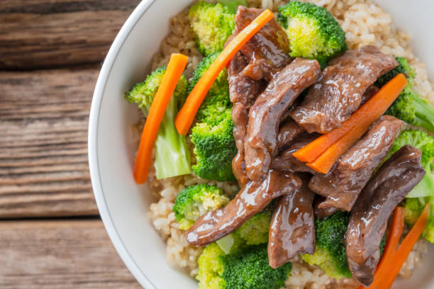 istock Stir Fried Beef and Broccoli over Brown Rice 1077258258
