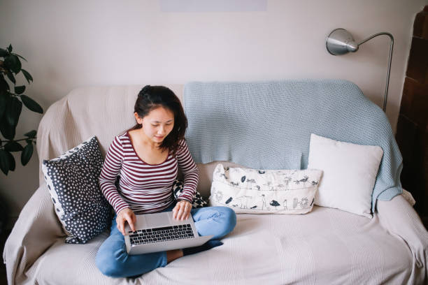 istock Young Asian woman relaxing at home 1077260120
