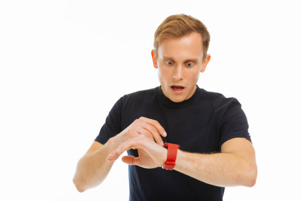 istock Nice blonde man checking the time on his watch 1077260668
