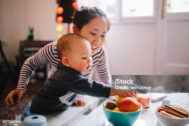 Young Asian Mom Giving Food To Her Baby Boy Stock Photo - Download Image Now - Eating, Family, Baby - Human Age