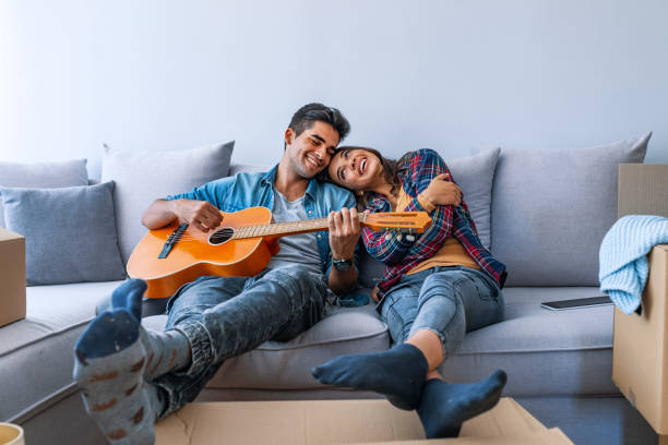 istock Cute couple taking a break from unpacking in their new home 1077265734