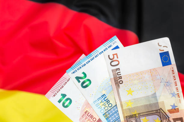 istock Euro bills against German flag. 1077265740