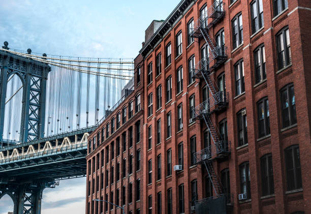 Last sun hitting red brick district in Dumbo, Manhattan bridge in the back