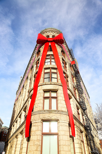 large red ribbon and bow on The Flour and Grain Exchange Building. vertical
