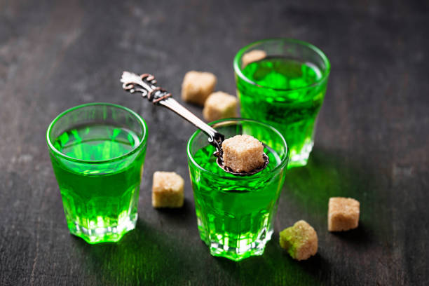 Glasses of absinthe with brown sugar Glasses of green alcoholic drink absinthe with brown sugar absinthe spoon stock pictures, royalty-free photos & images