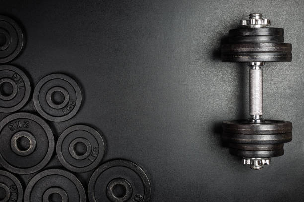Gym dumbbells with black metal weights 1kg and 2kg on black background with copy sapce, Photograph taken from above. Gym dumbbells with black metal weights 1kg and 2kg on black background with copy sapce, Photograph taken from above. mass unit of measurement photos stock pictures, royalty-free photos & images