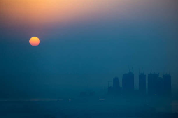 istock The Sun over a city. Full visible red to yellow gradient. Zoom close up 1077292840