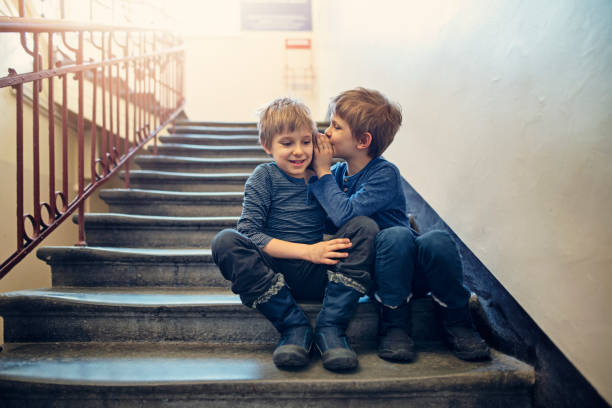 little boys whispering secrets - segredo criança imagens e fotografias de stock