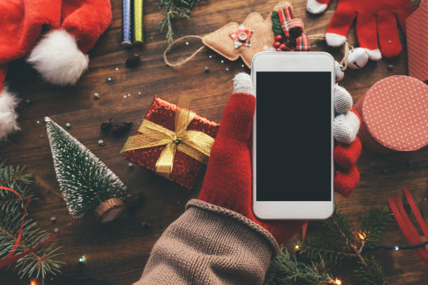 istock Smartphone in hand for Christmas season mock up 1077296286