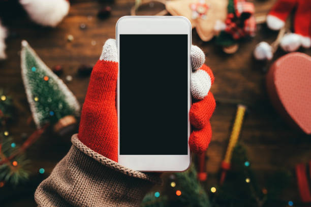 istock Smartphone in hand for Christmas season mock up 1077296486