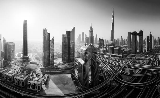 Dubai skyline in the morning, panoramic aerial top view to downtown city center landmarks at sunrise. Famous viewpoint, Black and white toned stock photo