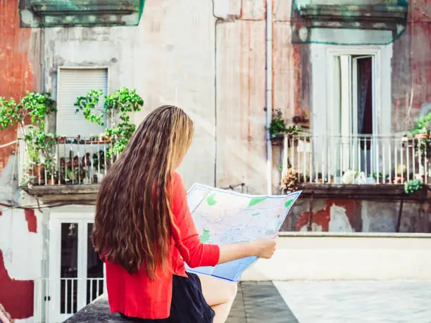 Photo of Cute woman holding a map. Travel and tourism concept