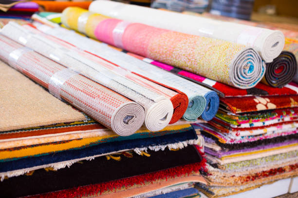 istock Stack of multicolored quality rugs  at carpet shop 1077300204