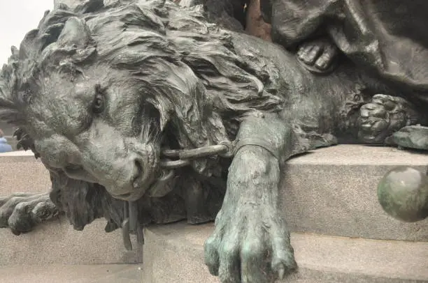 Photo of Lion statue encircled in chains on the coast of Venice.