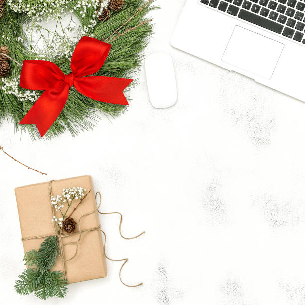 istock Office desk laptop Christmas decoration wreath gift flat lay 1077309230