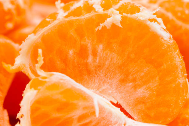 istock Peeled mandarin oranges on white background 1077311456