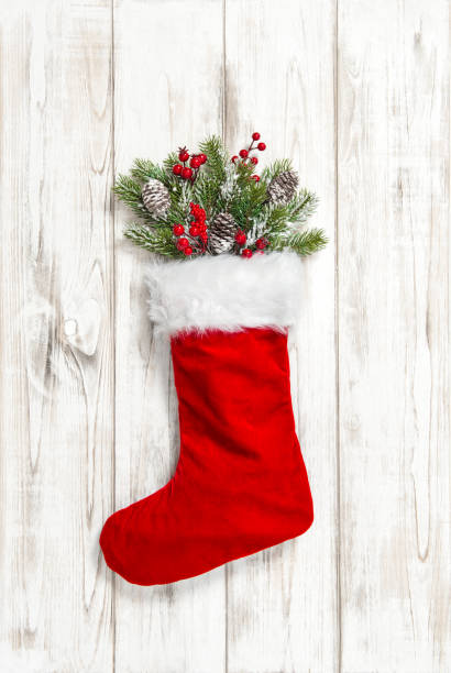 istock Christmas stocking red decoration wooden background 1077311650