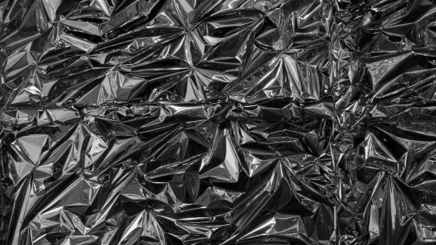 istock Silver metal foil, wrinkled and shiny. 1077312048