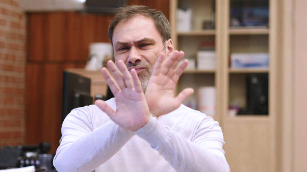 istock Rejecting, Disliking Gesture by Middle Age Man in Office 1077312446